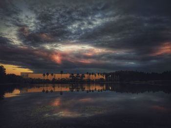 Scenic view of sea against cloudy sky at sunset