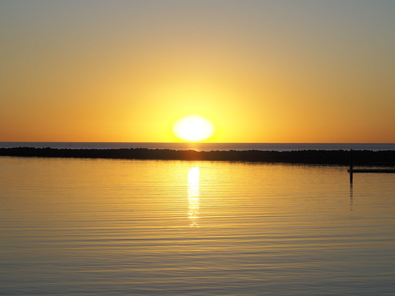 SCENIC VIEW OF SEA AGAINST ORANGE SKY DURING SUNSET