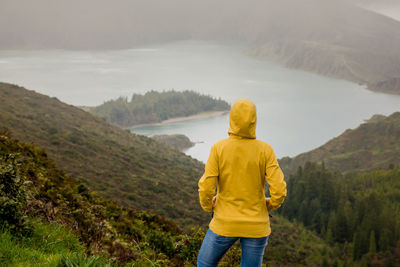 Rear view of woman standing on mountain