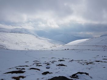 Scenic view of snow covered mountains against sky