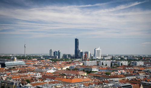 View of cityscape against cloudy sky