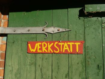 Close-up of text on wooden door