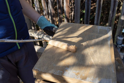 Midsection of man working at workshop