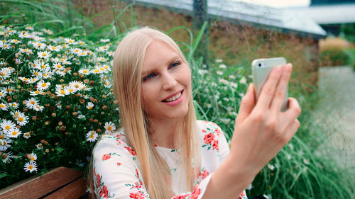 Portrait of young woman using smart phone outdoors