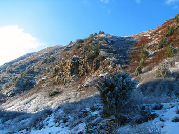 Low angle view of mountain against blue sky