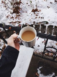 Close-up of woman holding hot coffee