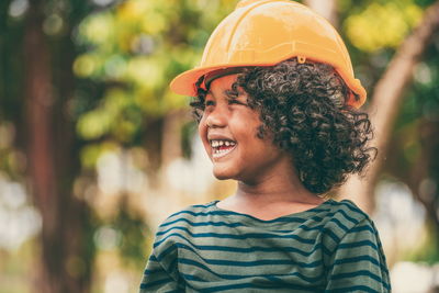 Portrait of smiling boy standing outdoors