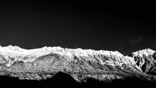 Scenic view of snowcapped mountains against clear sky