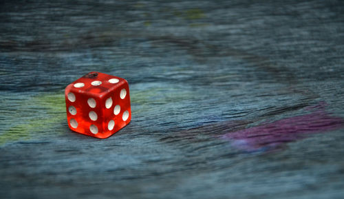 Close-up of red dice on wooden table