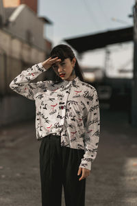 Young woman looking at camera in city