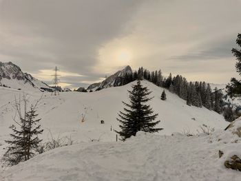 Scenic view of snow covered mountains against sky