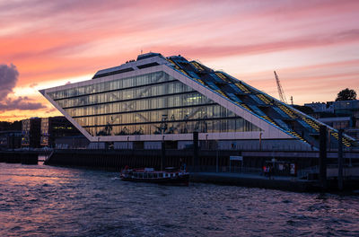 Bridge over river against sky during sunset