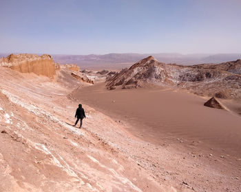 Full length of woman on arid landscape against sky