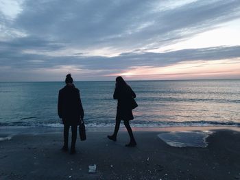 Rear view of silhouette people on beach