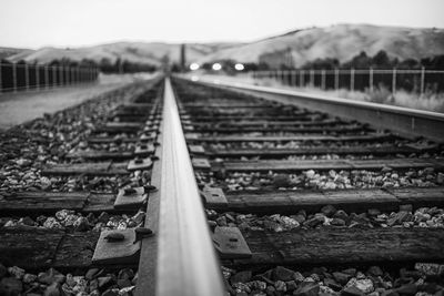 Surface level of railroad tracks against sky