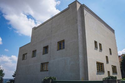 Low angle view of building against cloudy sky