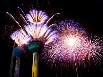 Low angle view of firework display at night