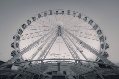 Low angle view of ferris wheel against sky