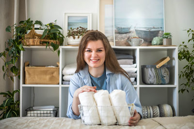 Portrait of young woman sitting at home