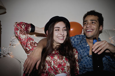 Portrait of smiling young couple sitting
