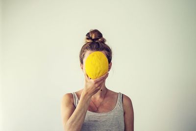 Portrait of woman wearing mask against white background