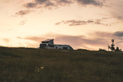 Scenic view of field against sky during sunset