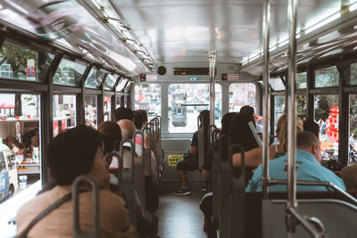 Rear view of people sitting in cable car