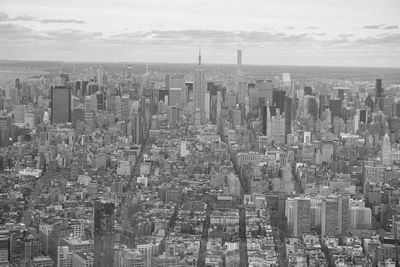 Aerial view of modern buildings in city against sky