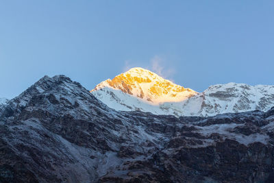 Scenic view of snowcapped mountains against clear sky