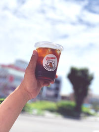 Close-up of hand holding drink