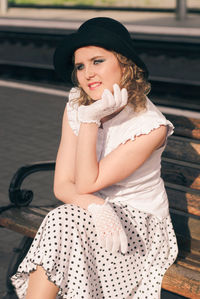 Portrait of a smiling young woman sitting outdoors