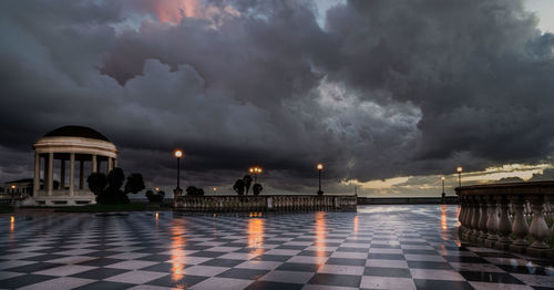 Buildings against cloudy sky during sunset