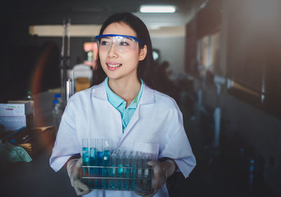 Female scientist examining chemical in laboratory