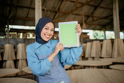 Portrait of young woman using mobile phone