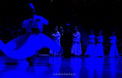 People dancing in illuminated lights at night