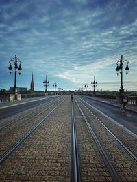 Railroad tracks by street against sky bordeaux 