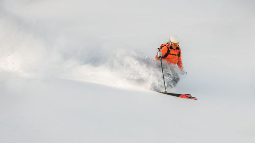 Low angle view of people skiing on snow