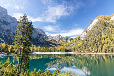 Scenic view of lake by mountains against sky