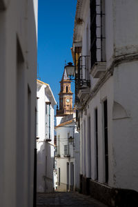 Alley amidst buildings against sky in city