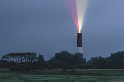 Germany, schleswig-holstein, pellworm, pellworm lighthouse casting colorful light at dusk