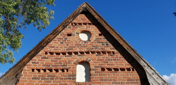 Low angle view of building against clear blue sky