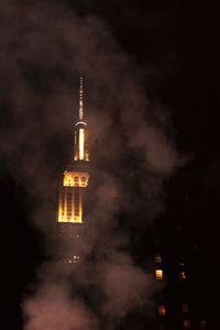 Low angle view of illuminated tower against sky at night