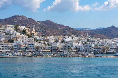 Townscape by sea against sky