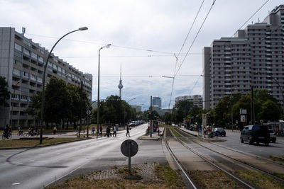 View of city street against cloudy sky