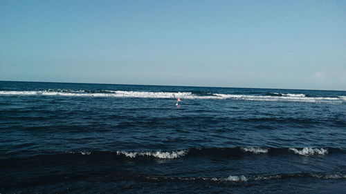 Scenic view of sea against clear blue sky