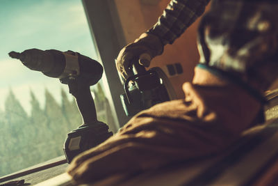 Midsection of man holding camera