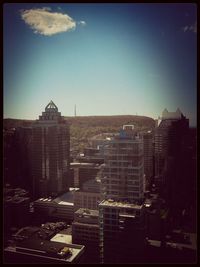 View of cityscape against blue sky