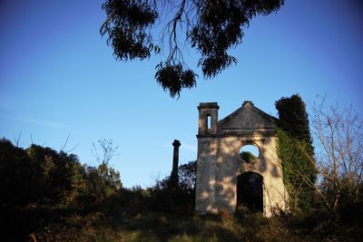 Low angle view of historical building against blue sky