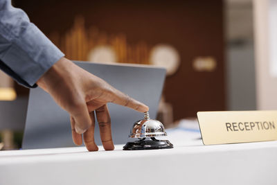 Cropped hand of man using laptop on table