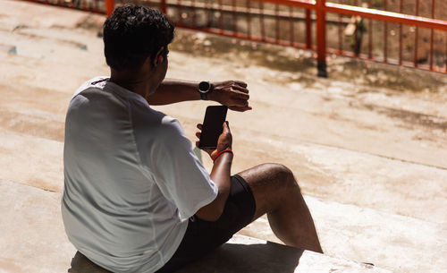 Rear view of man photographing